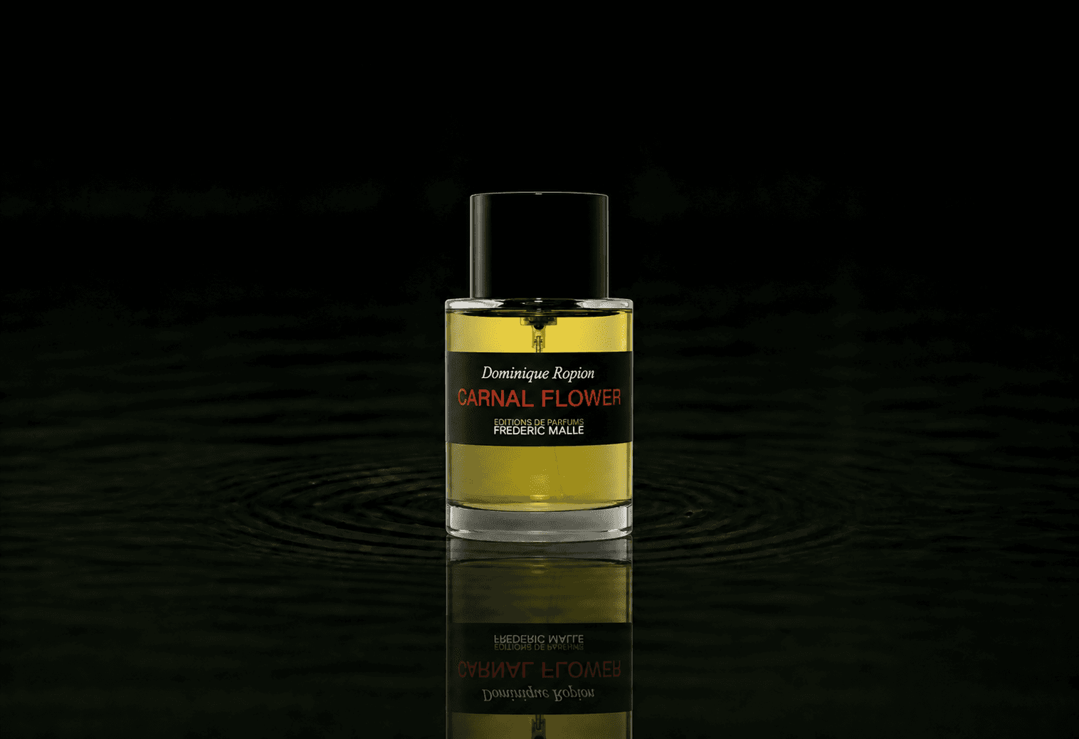 Editions de Parfums Frederic Malle Carnal Flower fragrance bottle floating above dark water
